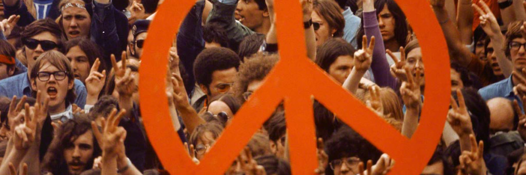 ca. 1970, Washington, DC, USA --- A large peace sign is held up by activists during a Vietnam War demonstration on Capitol Hill. --- Image by © Wally McNamee/CORBIS